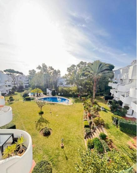 a view from a balcony of a building with a pool at Pinos de Calahonda duplex in Sitio de Calahonda