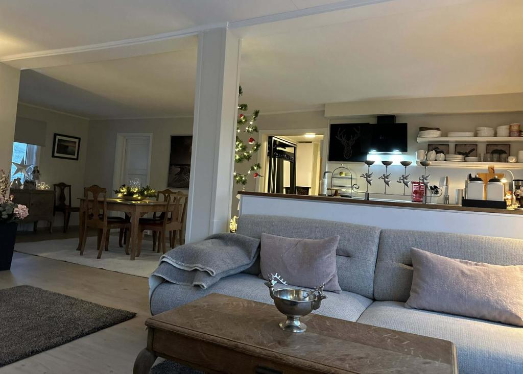 een woonkamer met een bank en een tafel bij Herb Farm Guesthouse in Senja