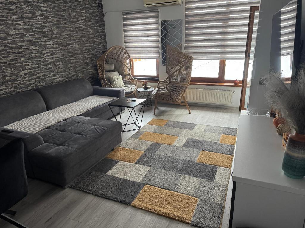 a living room with a couch and a rug at Jules Cozy Place in Bucharest