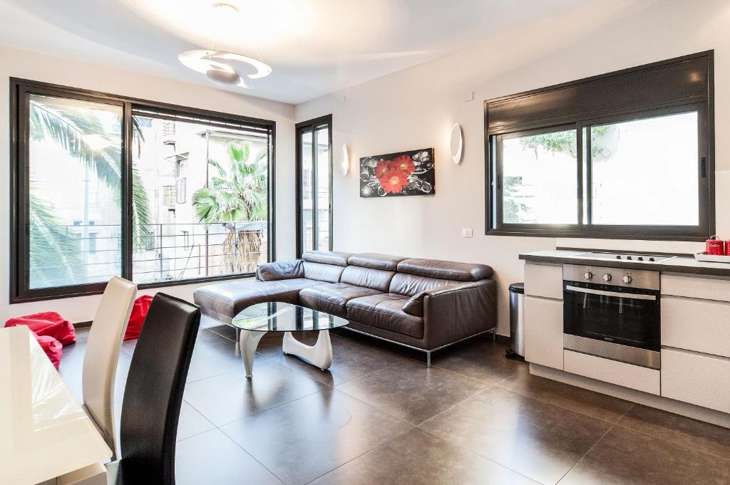 a living room with a couch and a table at Very High Standard in The Best Location by Sea N' Rent in Tel Aviv