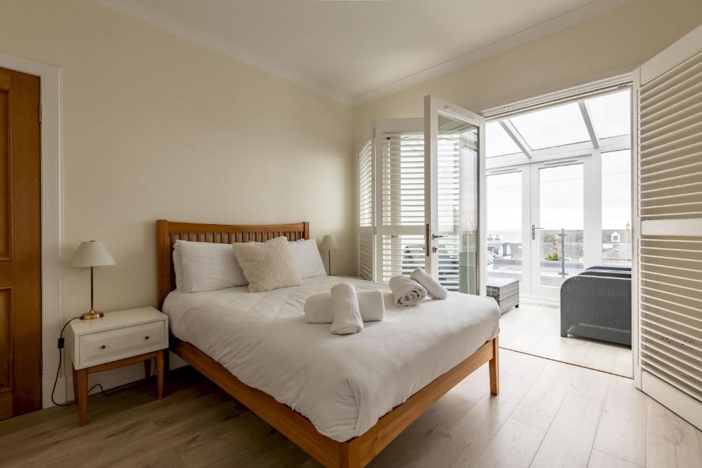 a bedroom with a large bed with white sheets and pillows at Bonnington House - Elie in Elie