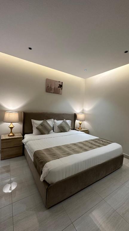 Ένα ή περισσότερα κρεβάτια σε δωμάτιο στο أوان ريزدنس Awan Residence