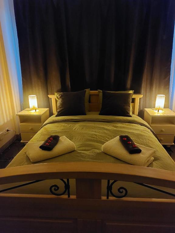 a bedroom with two pillows on a bed with two lamps at El Silencio Apartments in Zurich