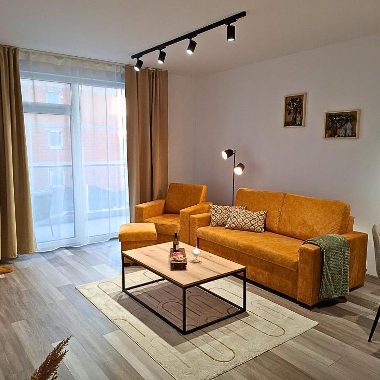 a living room with a couch and a coffee table at Apartmán 103 in Spišská Nová Ves