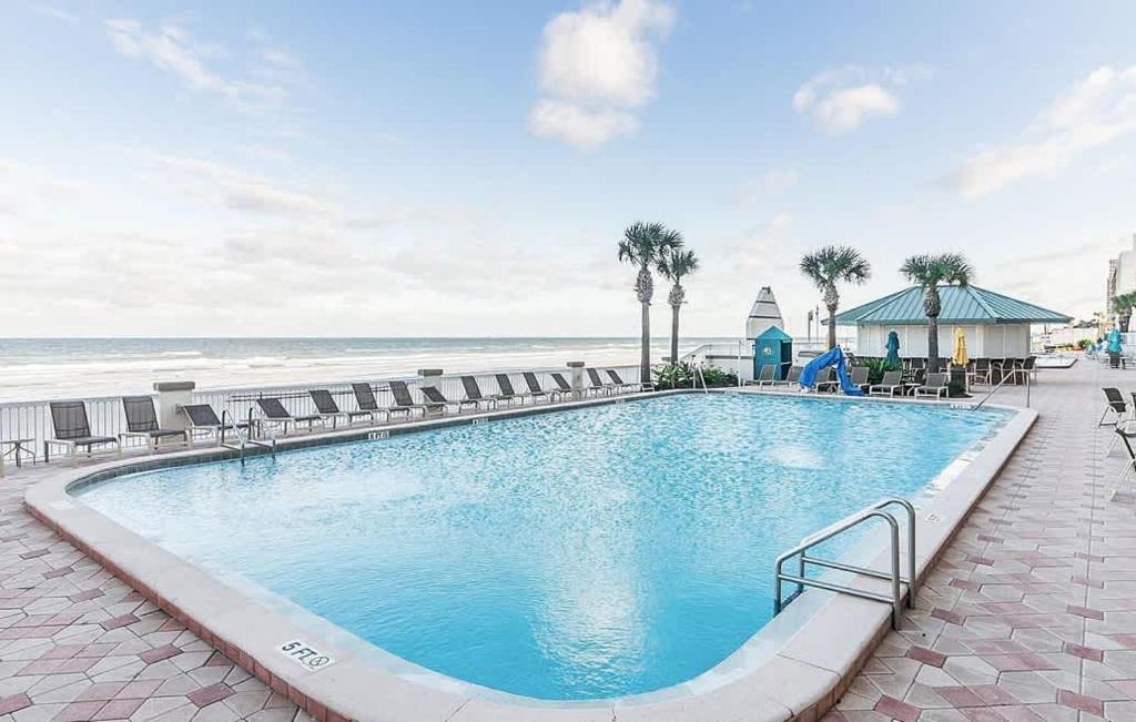 a large swimming pool next to the beach at Beach Access Elegant Studio near Top Attractions in Daytona Beach
