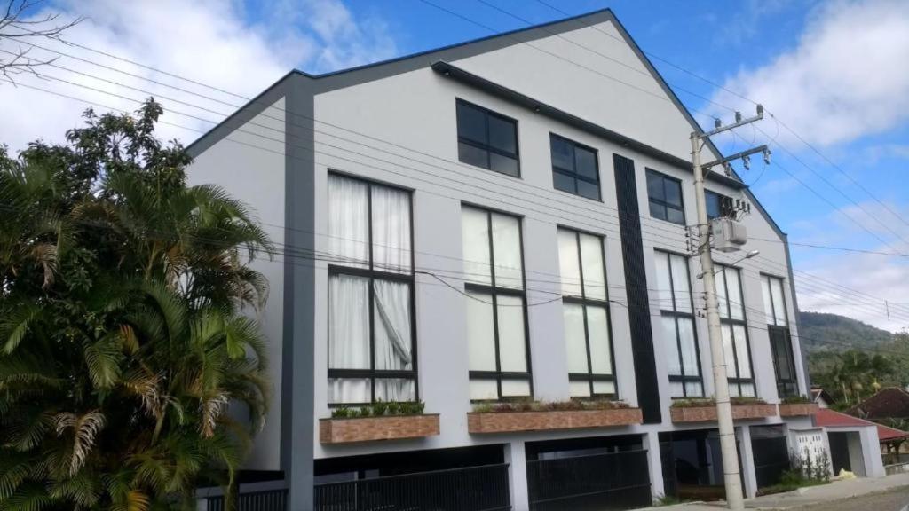 a rendering of a white building with windows at Apartamento Texas in Pomerode