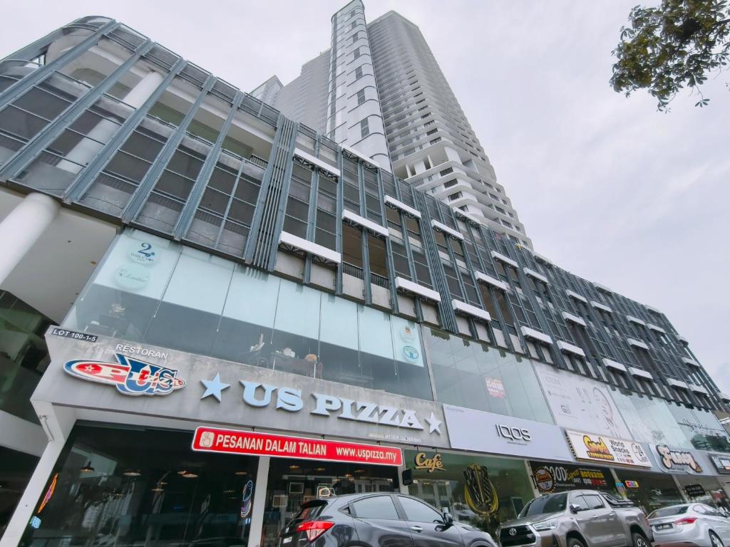 a large building with cars parked in front of it at Landmark Seaview Cozy Family Suite with Balcony 6 Pax in Tanjong Tokong