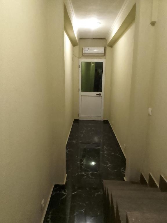 a hallway with a door and a floor with water at O Cantinho da Leninha in Benguela