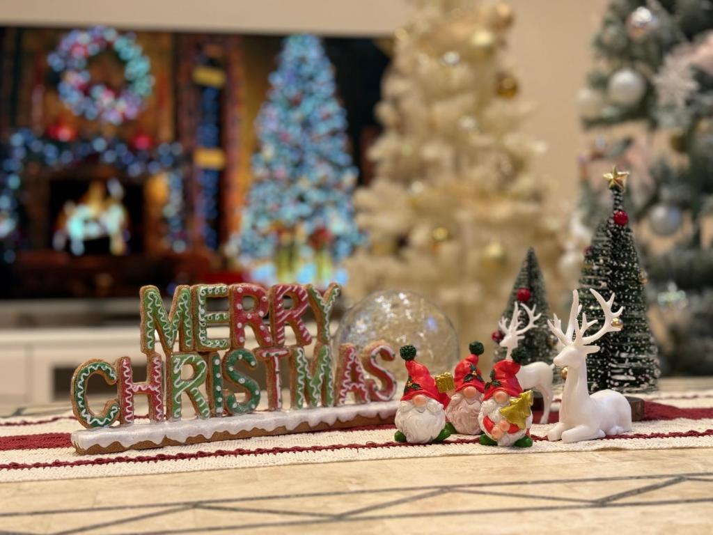 a merry christmas sign on a table with christmas decorations at リゾートヴィラ宮島 Sunset terrace in Hatsukaichi
