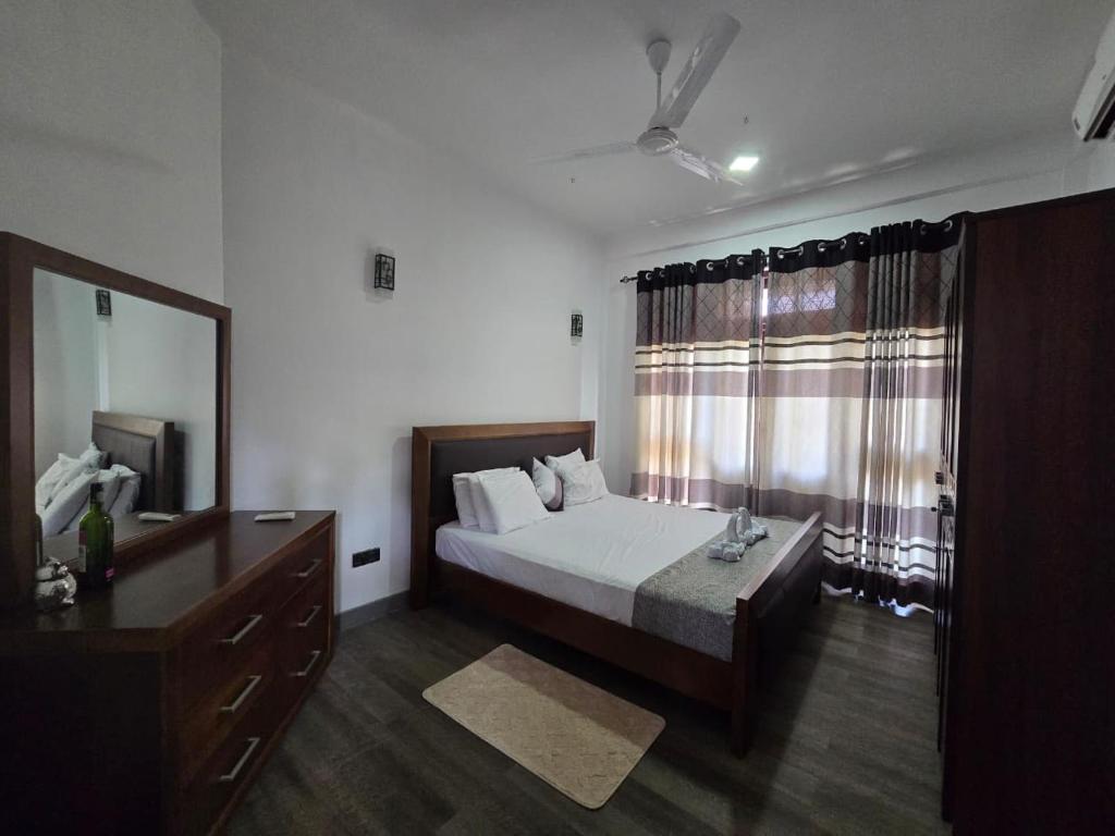 a bedroom with a bed and a large window at Villa Bloomscape in Galle