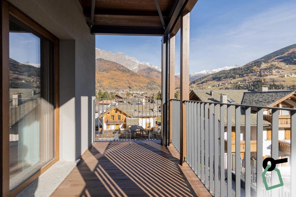 a balcony with a view of the mountains at HOTIDAY Bormio Apartments in Bormio
