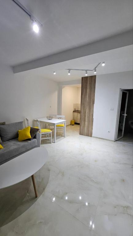 a living room with a couch and a table at Spring 4 in Petrovaradin