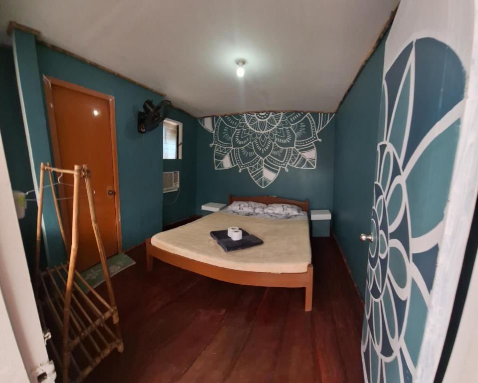 a small bedroom with a bed in a room at Gugma Tiu Homestay Port Barton in Manila
