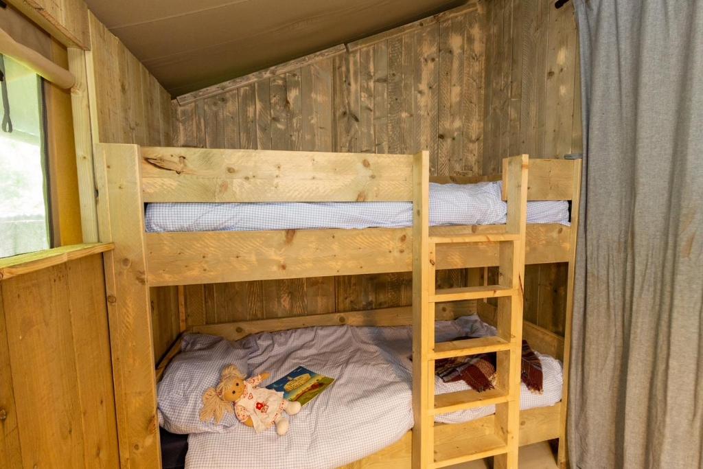 a bedroom with two bunk beds in a cabin at Leafy Fields Glamping in Ashill