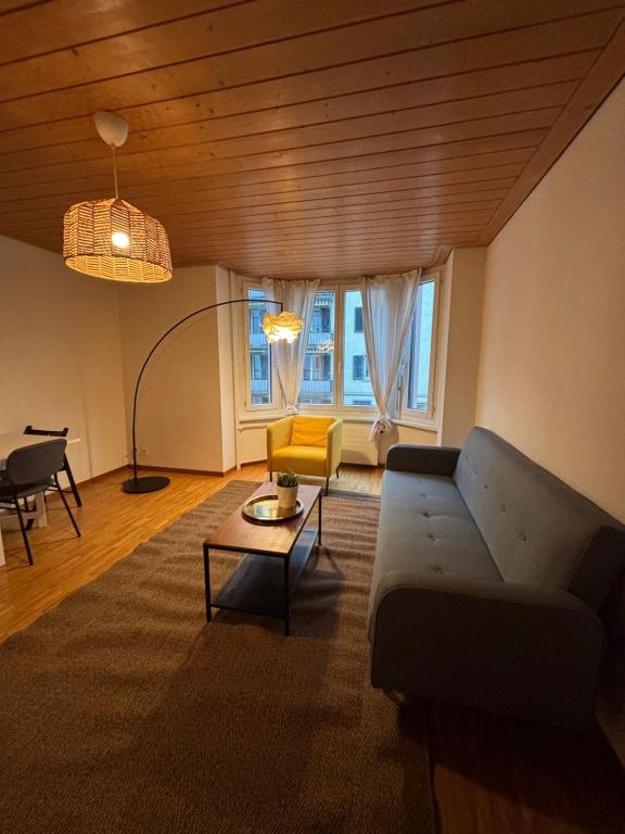 a living room with a couch and a table at Zurich Essentials Simple Apartment in Zürich