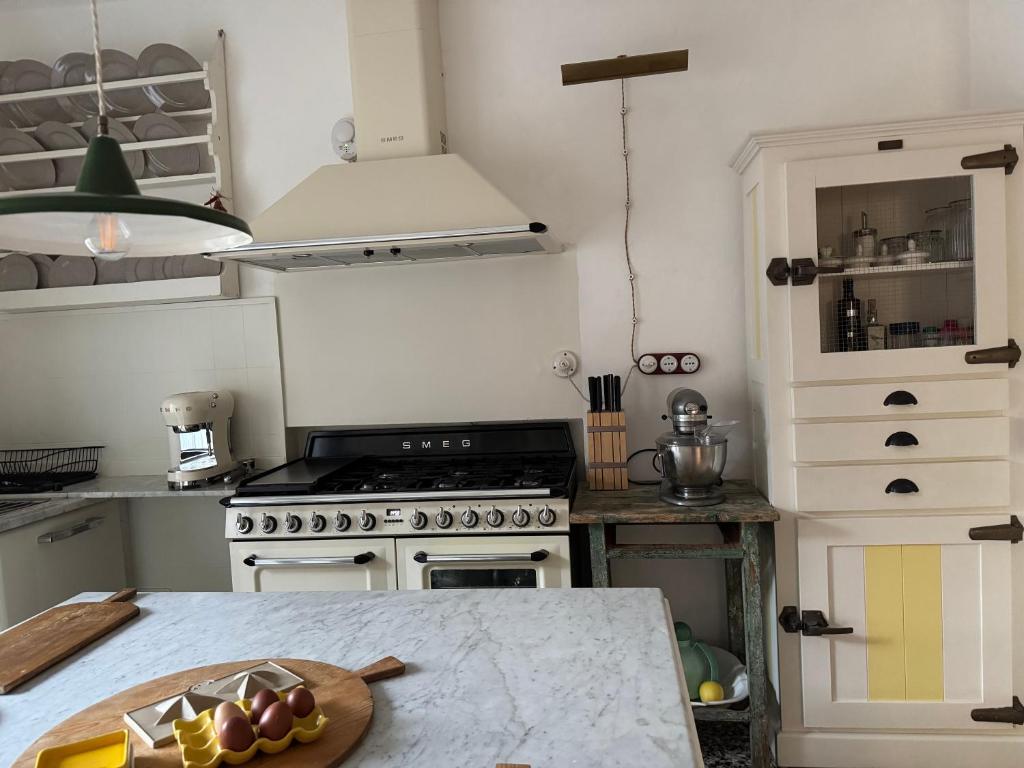a kitchen with a stove and a counter top at Le Vetrate sul Lago Lake Como Amazing View in Nesso