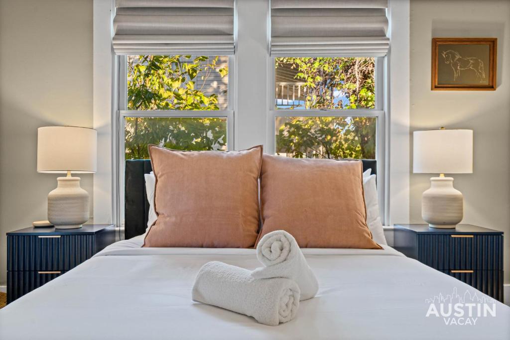 a bedroom with a bed with a towel on it at East Austin 2BR 1BA w Patio and Grill, Pet-Friendl Walk to 6th By Austin Vacay in Austin