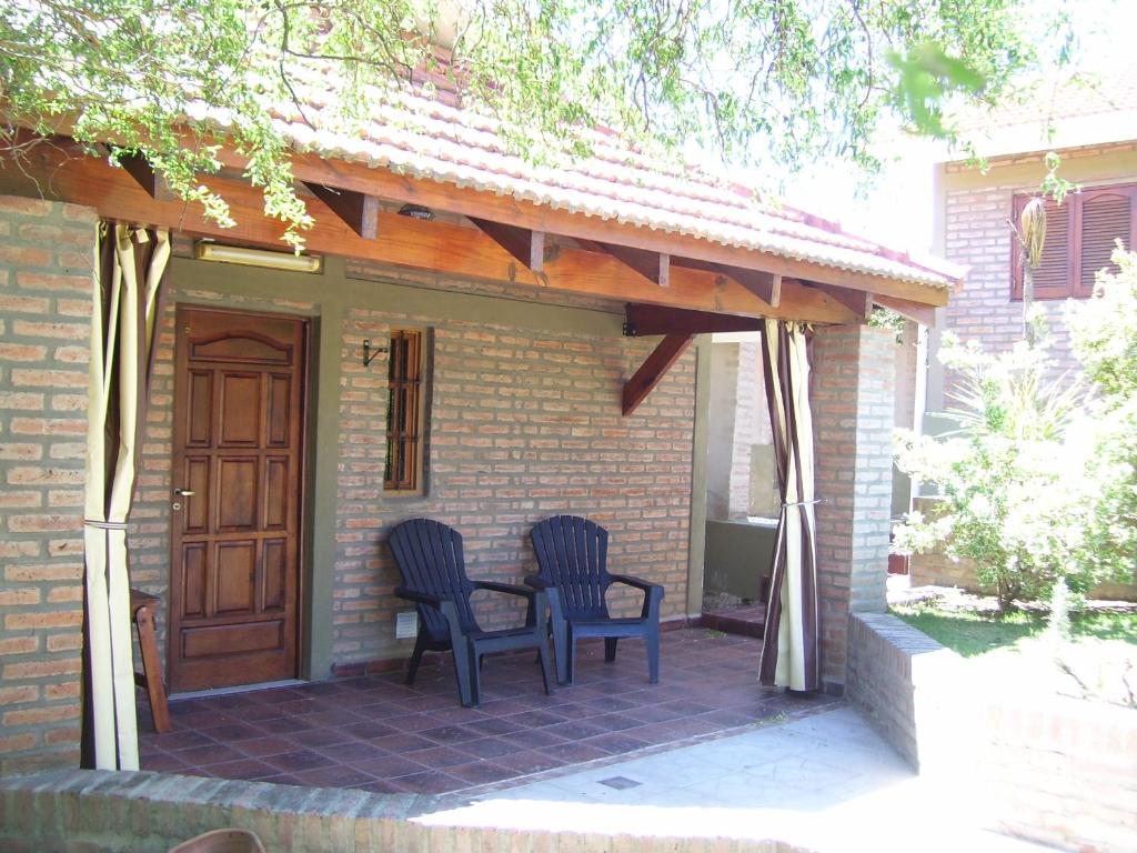 two chairs and a table on a patio at Cabañas La Morada de Tanti in Tanti