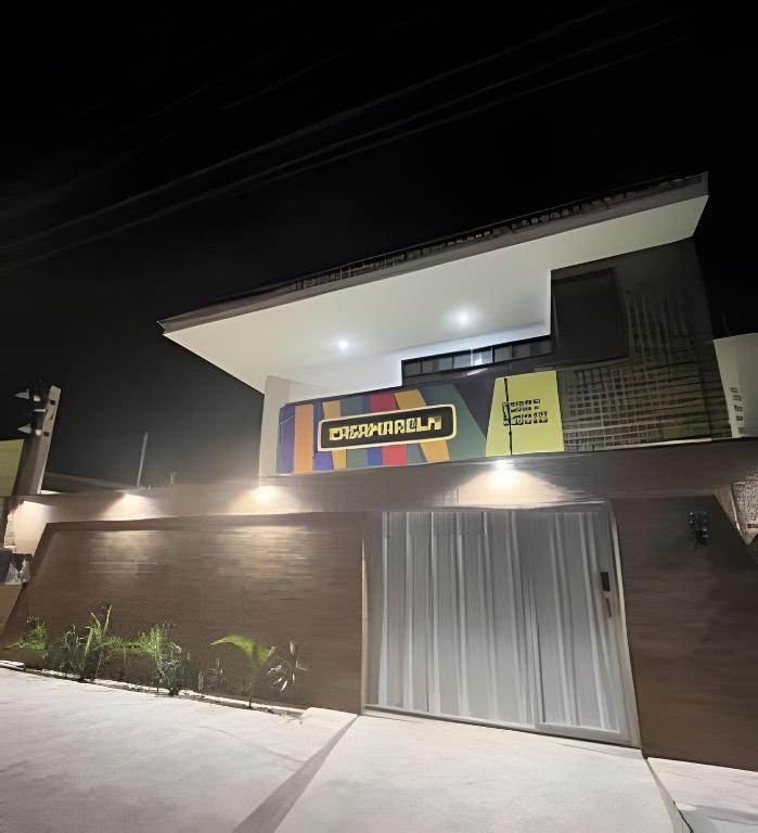 a building with a sign above a garage at Studios Casamarela in Mossoró