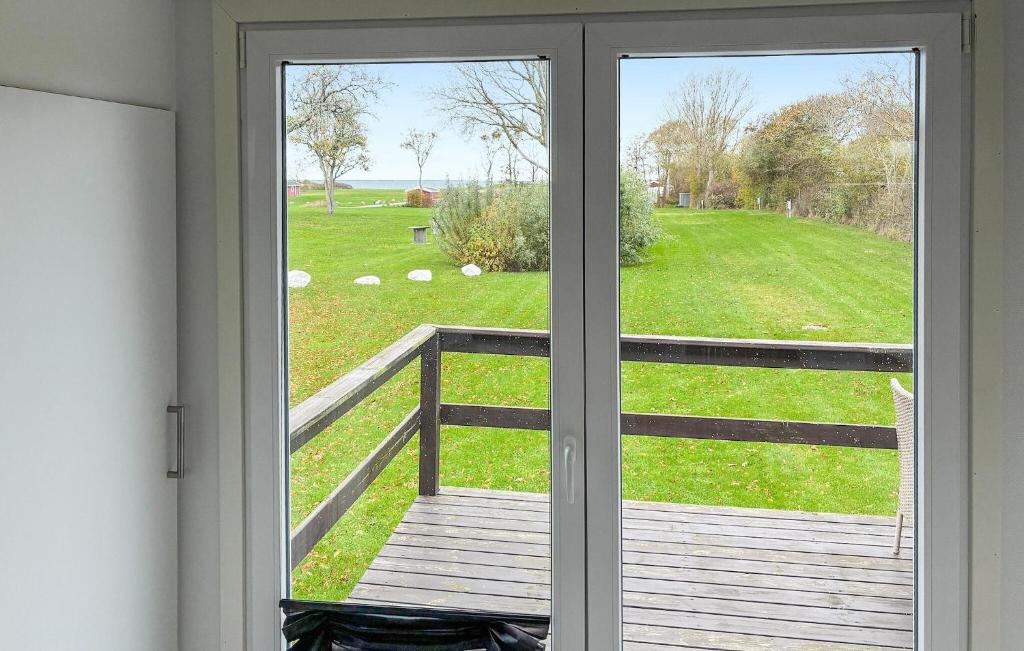 a sliding glass door with a view of a field at 2 Bedroom Amazing Home In Samsø in Kolby Kås