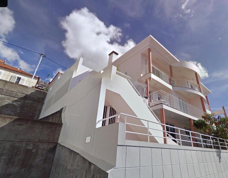 a white building with a balcony on top of it at Madeira Studio Salvador Rental in Funchal
