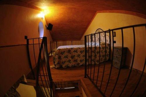 a staircase leading to a bedroom with a bed at Agriturismo Paradiso di Barchi in Lido Di Fondi