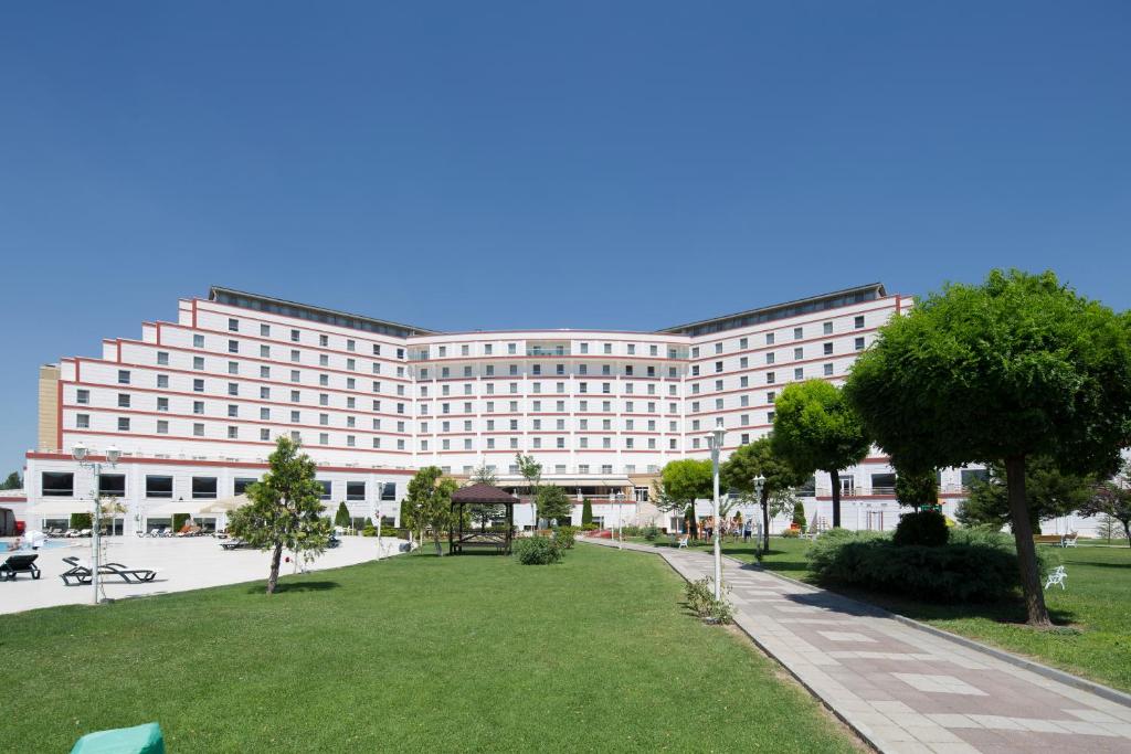 a large building with a park in front of it at Korel Thermal Resort in Afyon