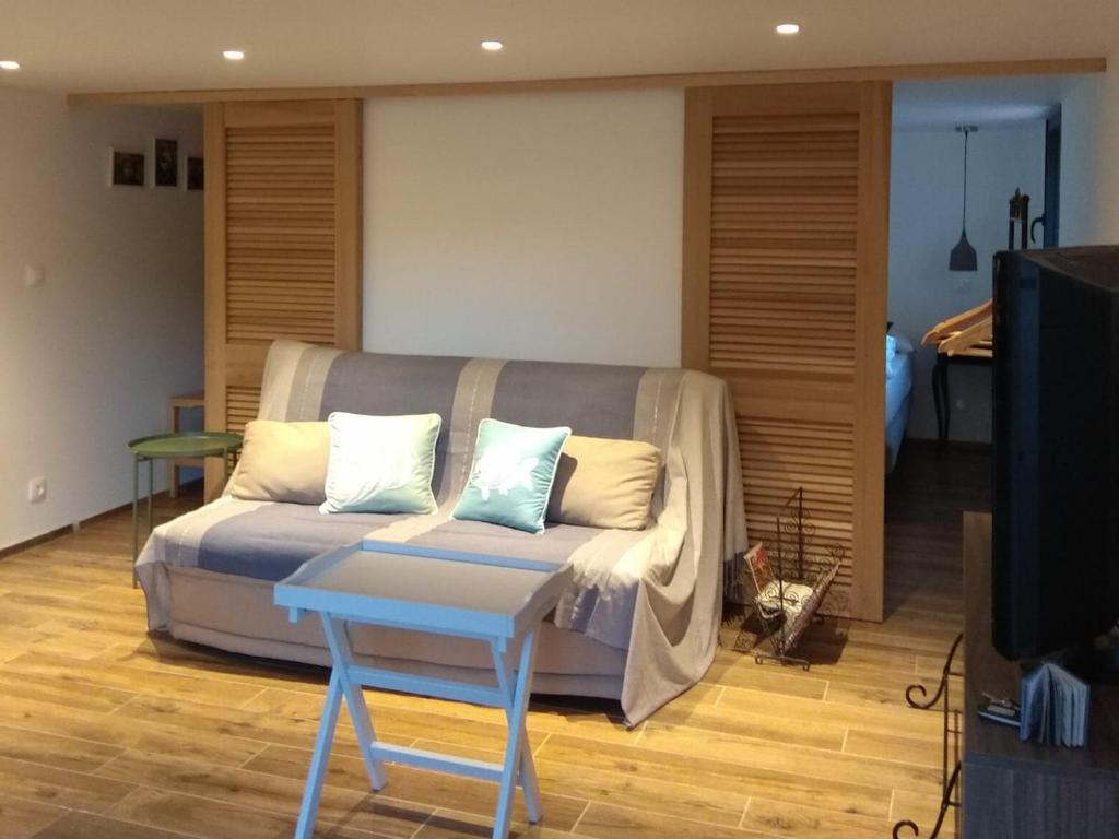 a living room with a couch and a table at La Corentine in Bandol