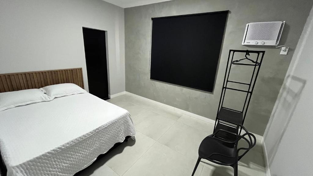 En eller flere senge i et værelse på Casa Vila Muriqui