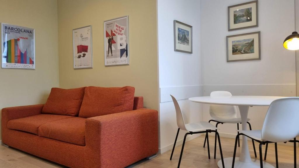 a living room with a chair and a table at Campo Marzio 6 in Trieste