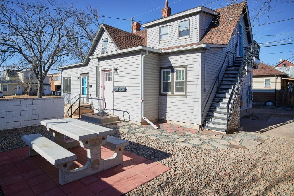 a white house with a picnic table in front of it at Capitol-Side • Downtown • Attic Harry-Potter Door in Cheyenne