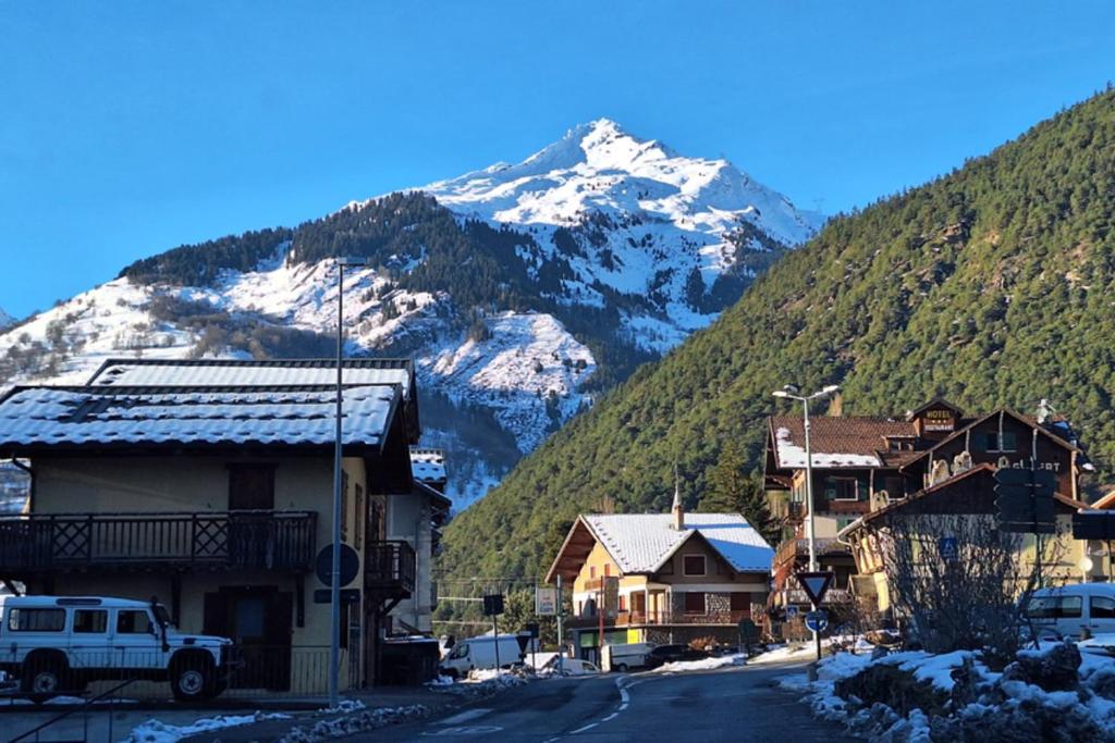 a small town with a snow covered mountain in the background at Modern apartment in the heart of Séez in Séez