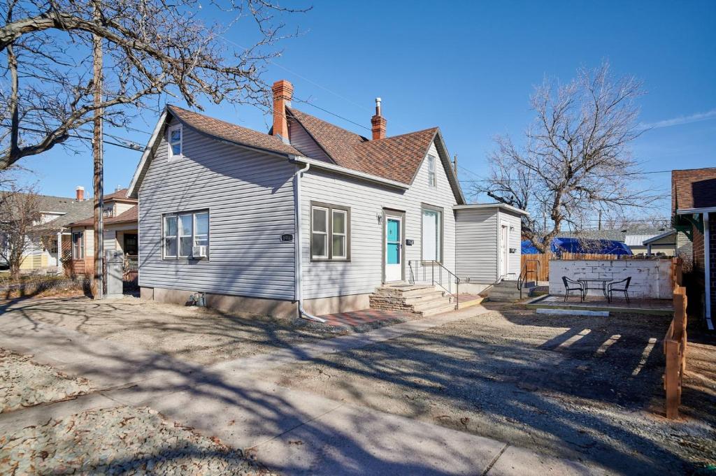 a white house with a blue door at Capitol-Side • Downtown • Basement Pirate Themed in Cheyenne