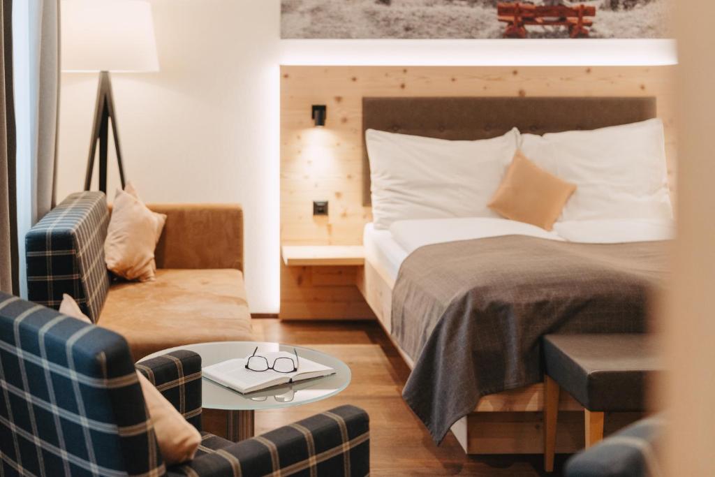 a hotel room with a bed and a chair at Boutique Hotel Waldegg in Lucerne