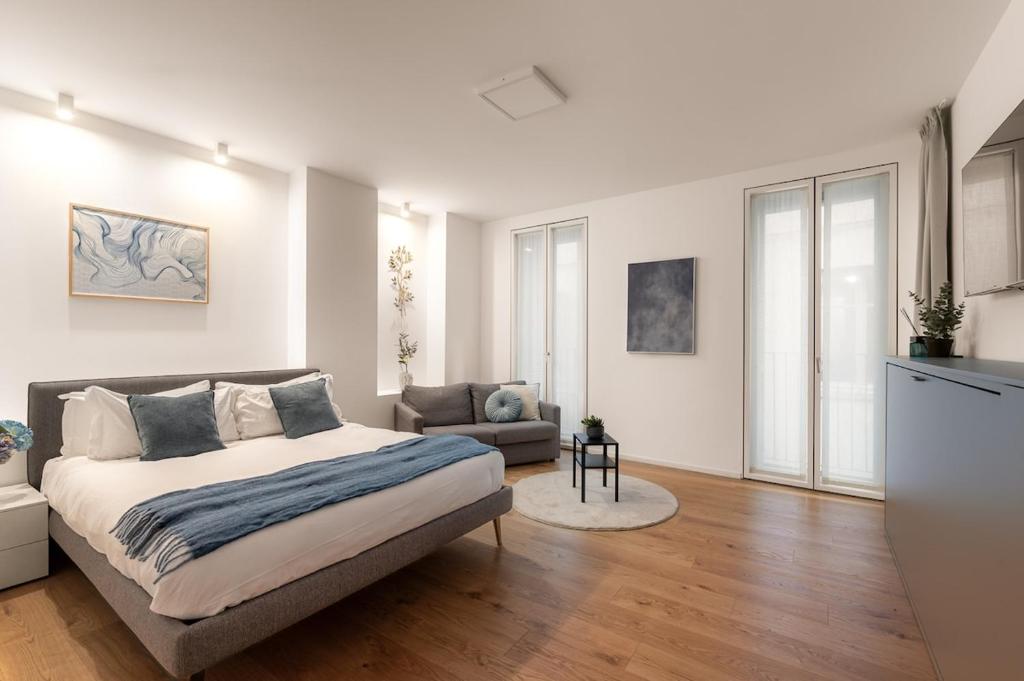 a bedroom with a bed and a living room at The Golden Duo Two luxury units in one building by Aura Luxury Collection in Como