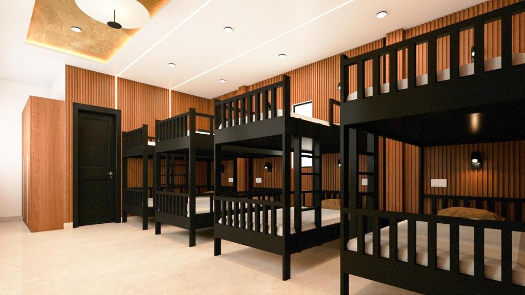 a row of bunk beds in a room at Cloudy Nandy Hills Poombarai in Kūkkāl
