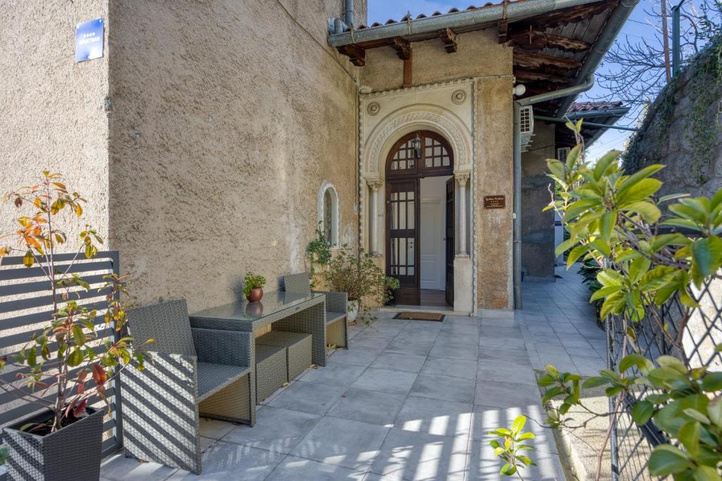 an entrance to a building with benches and plants at Aparatman Residence in Rijeka