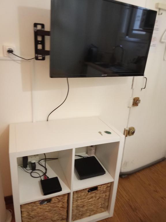 a tv on top of a white tv stand at Noël centre Lille in Lille