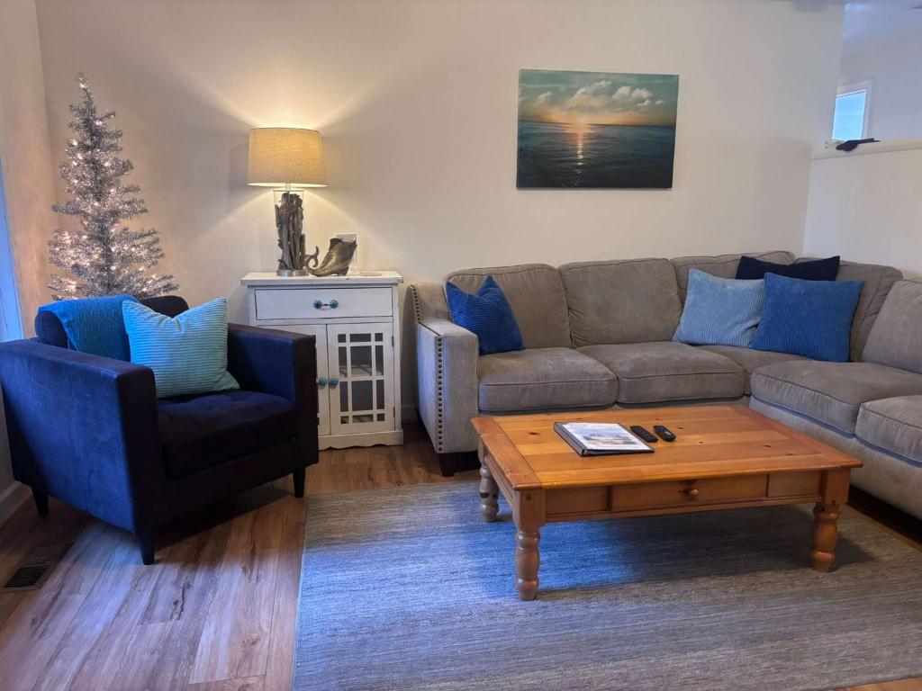 a living room with a couch and a coffee table at #StayInMyDistrict Cozy Rockaway Beach Cottage in Rockaway Beach