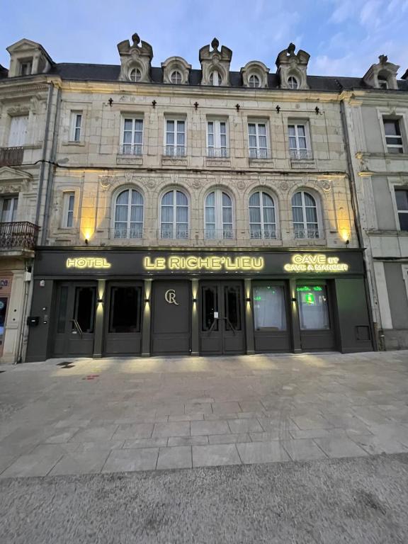 a facade of a building with a store at Hôtel Le Riche'Lieu in Luçon