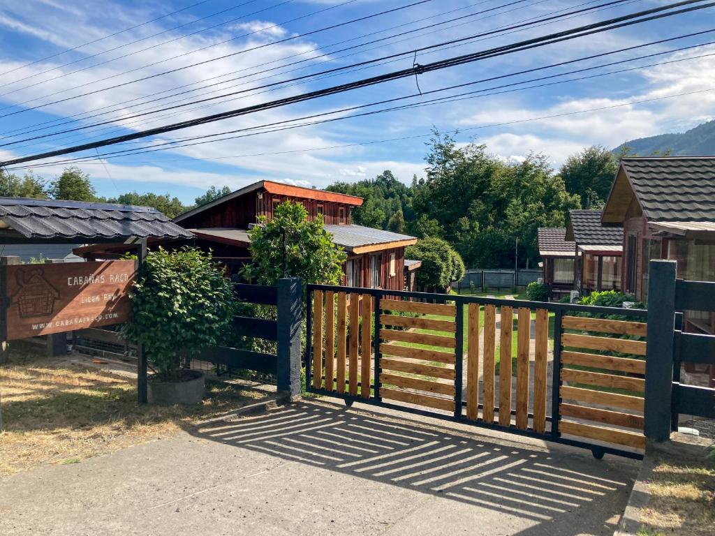 a wooden gate in front of a house at CABAÑAS RACO in Licán Ray
