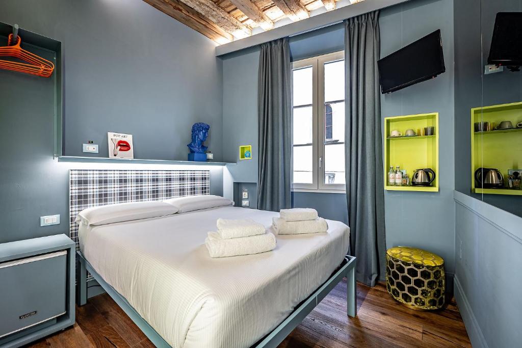a bedroom with a bed with towels on it at Pop Tower Florence in Florence