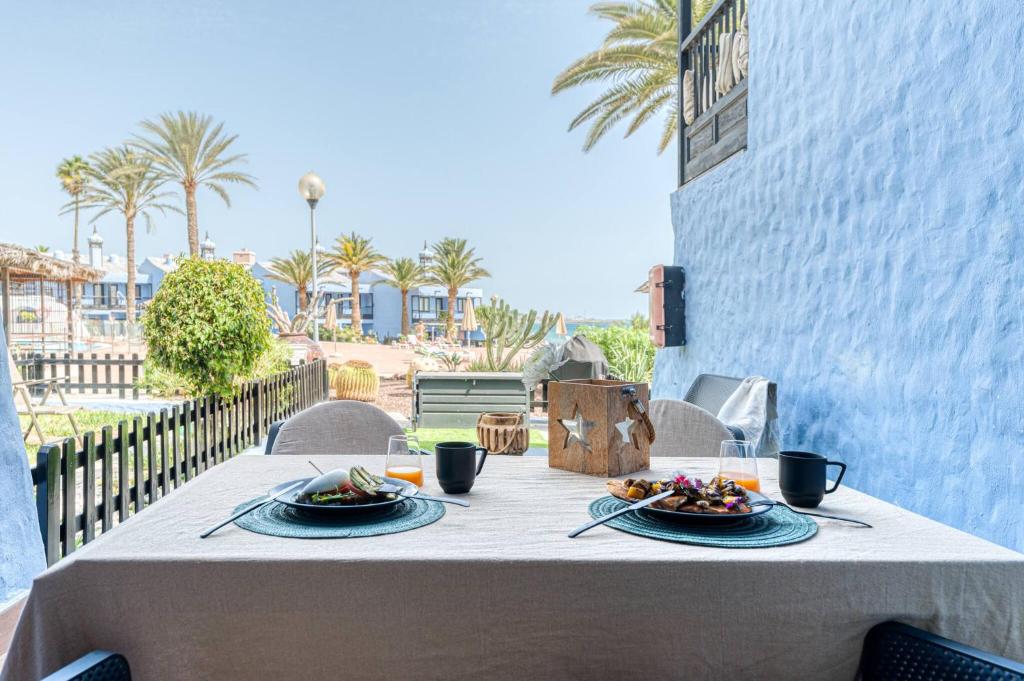 a table with plates of food on top of a balcony at Casa Tabera - Sun Club Playa del Águila in Playa del Aguila