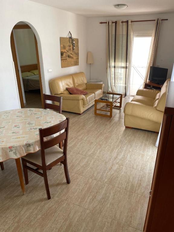 a living room with a table and a couch at Amarillo Apartment in Puerto de Mazarrón