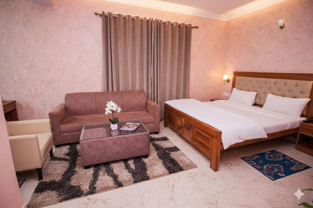 a bedroom with a bed and a chair and a couch at Hotel Airport residency in Rānchī