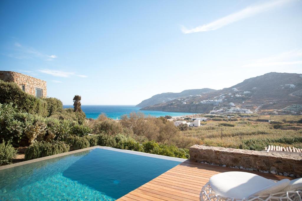 a swimming pool with a view of the ocean at Mileo in Kalo Livadi
