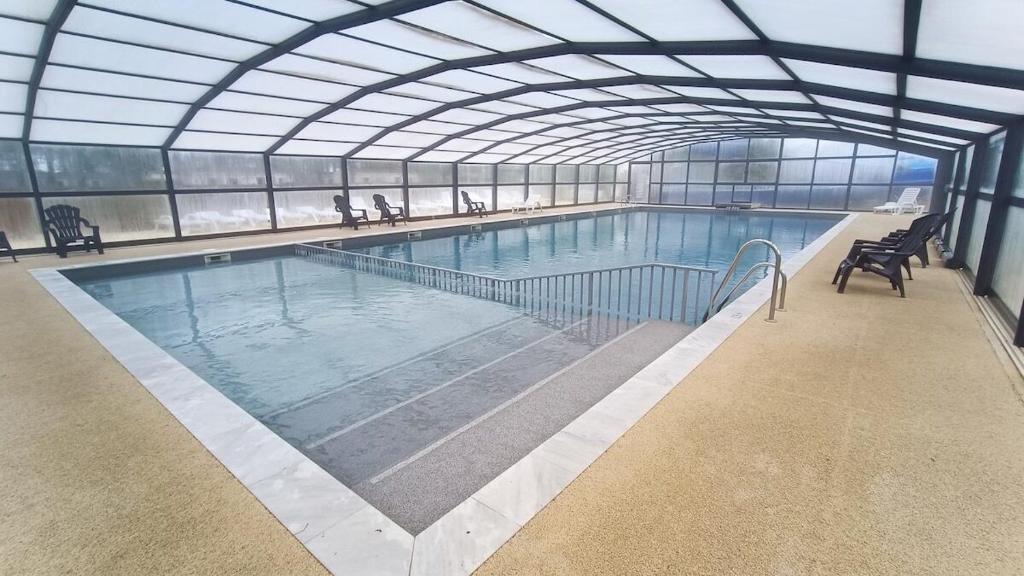 a large swimming pool in a building at Premi Home XL SUPERieur 6P 3ch-Puy duFou 25min in La Boissière-de-Montaigu