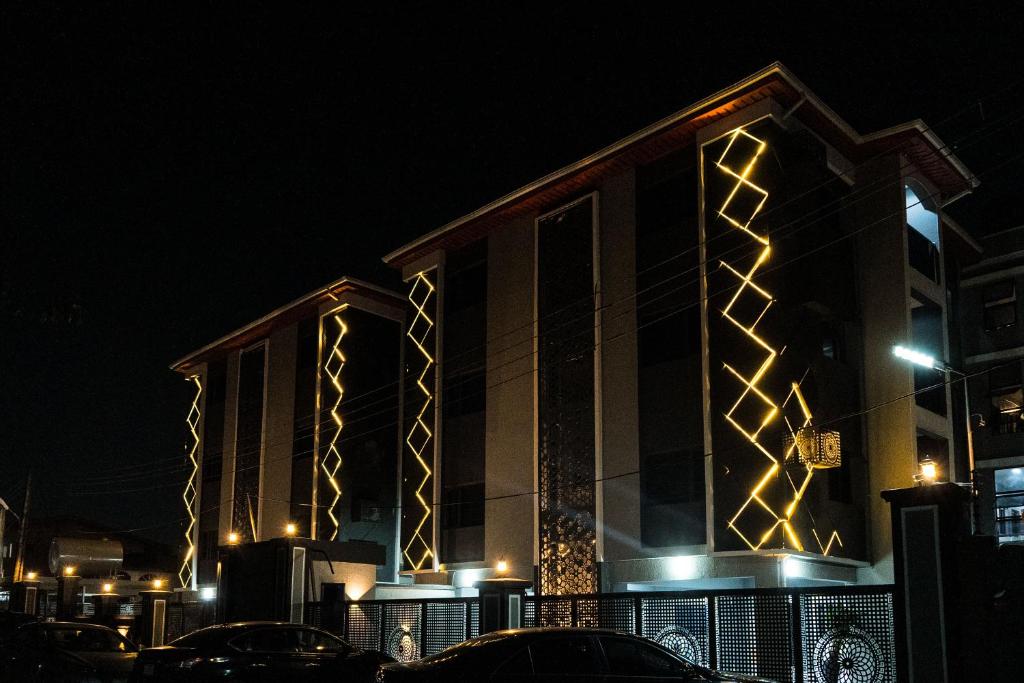 a building with lights on it at night at Main Avenue Residence Lagos in Lagos