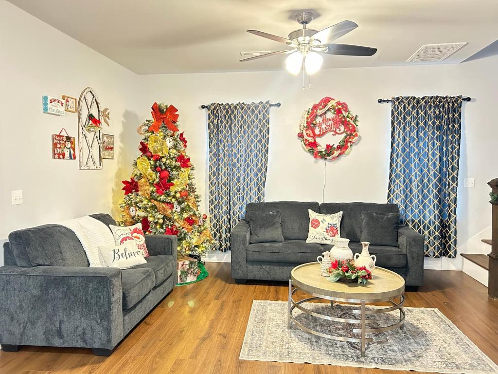 a living room with two couches and a christmas tree at My house your house in Fort Smith