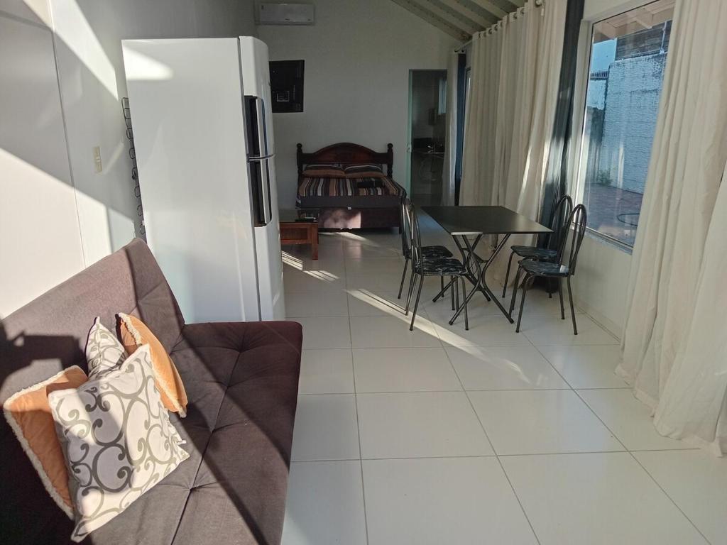 a living room with a couch and a table at Casa proximo ao aeroporto in Florianópolis